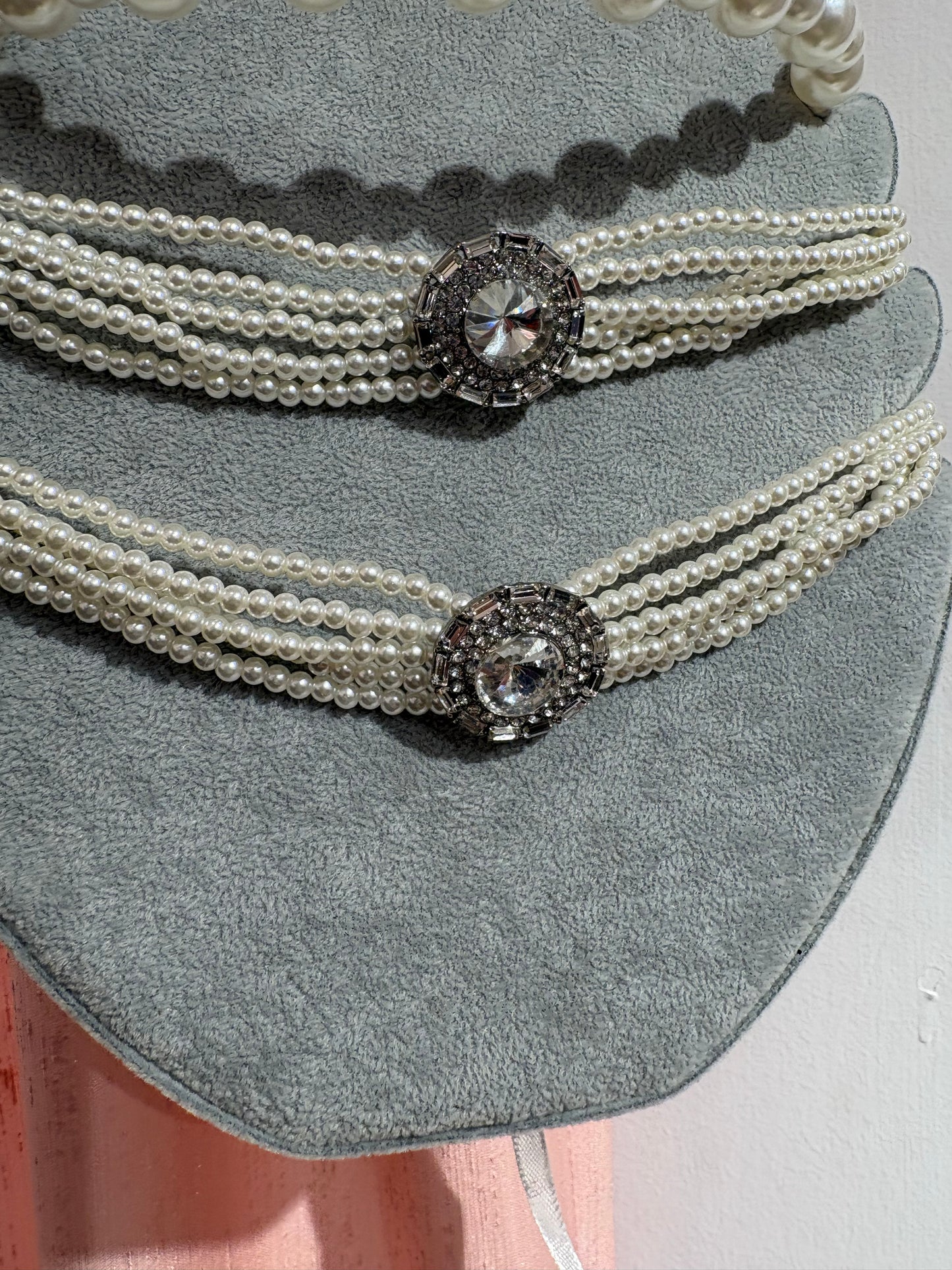 Statement multi-stand pearl chocker with a sparkling crystal centerpiece