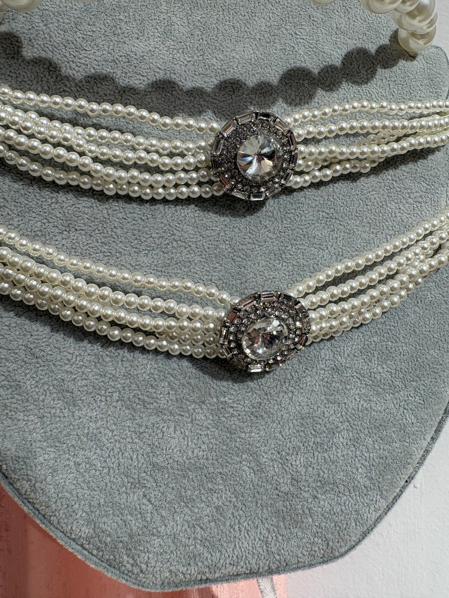 Statement multi-stand pearl chocker with a sparkling crystal centerpiece